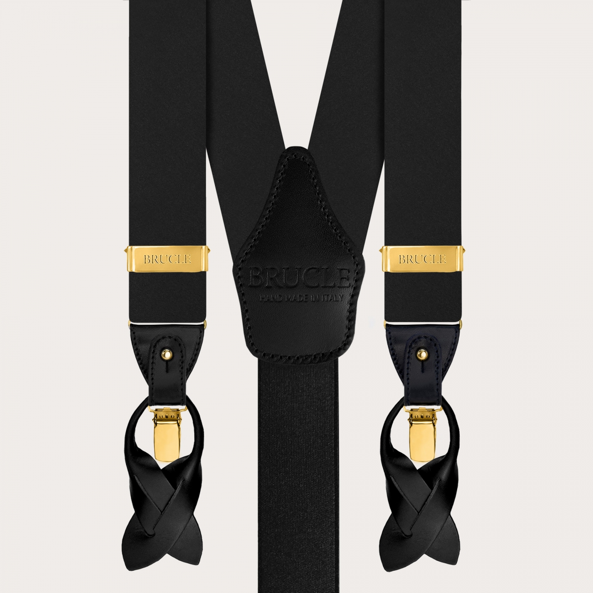 Coordinated set consisting of gold suspenders and black silk bow tie